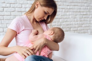 young-mother-feeding-breast-baby